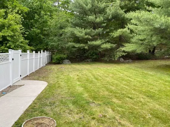 Finished white fence with fresh lawn